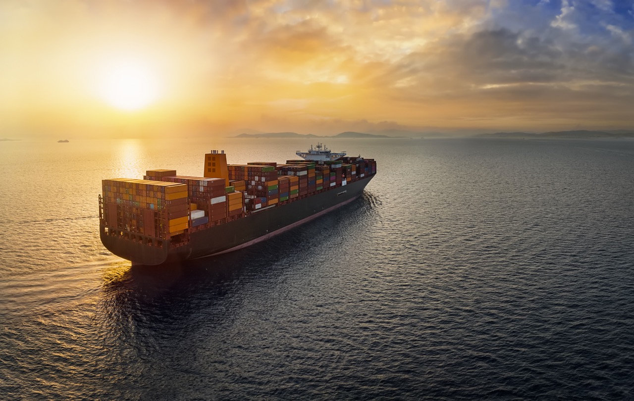 Container vessel under way at sunset